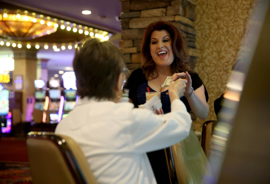 Maryanne Cumberledge, 80, of Las Vegas, left, gets her regular tea at her regular machine from ...