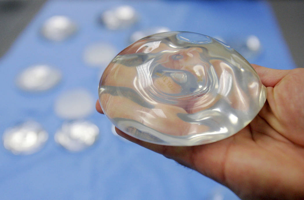 U.S. health officials are taking another look at the safety of breast implants, the latest review in a decades-long debate. (AP Photo/Donna McWilliam, File)