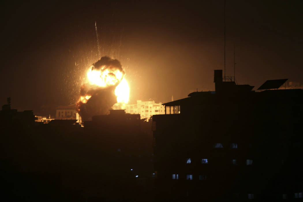 An explosion caused by Israeli airstrikes is seen from the offices of Hamas leader Ismail Haniyeh, in Gaza City, Monday, March 25, 2019. Israeli forces on Monday struck targets across the Gaza Str ...