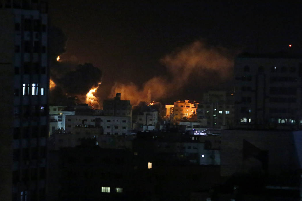 An explosion caused by Israeli airstrikes is seen from Hamas security building in Gaza City, Monday, March 25, 2019. Israeli forces on Monday struck targets across the Gaza Strip in response to a ...