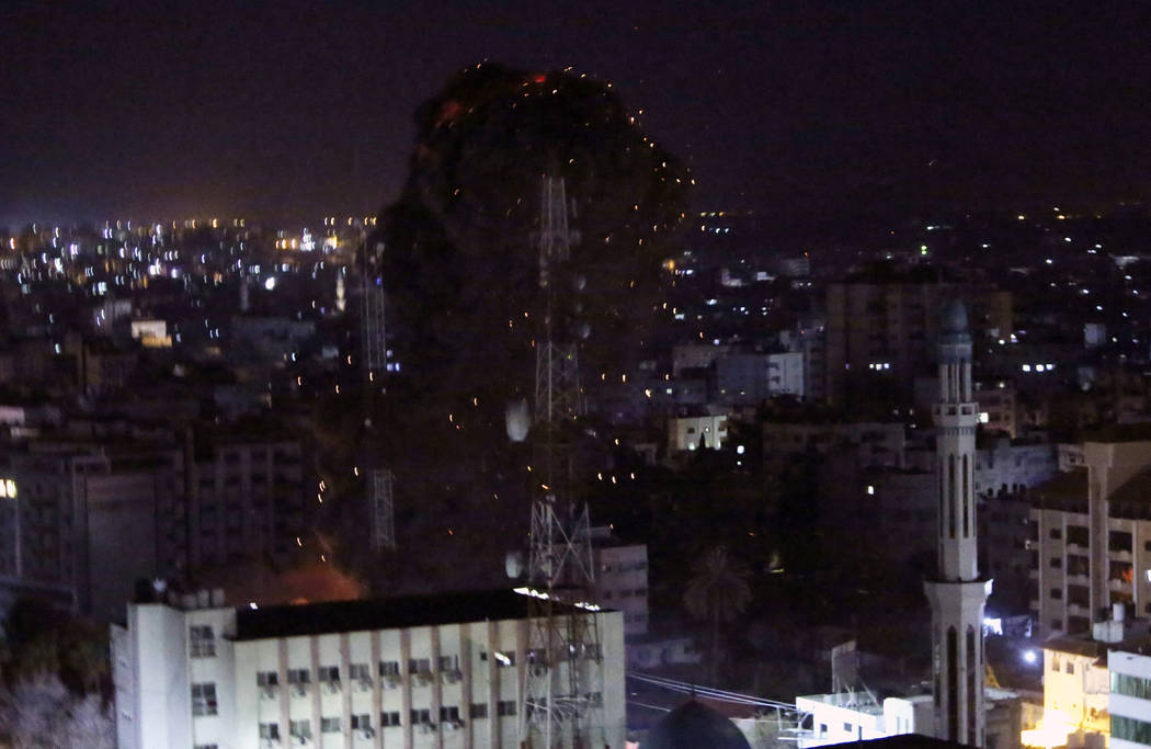 An explosion caused by Israeli airstrikes is seen in Gaza City, Monday, March 25, 2019. Israeli forces on Monday struck targets across the Gaza Strip in response to a surprise rocket attack from t ...