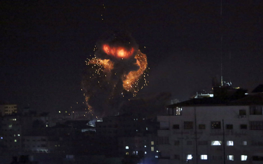 An explosion caused by Israeli airstrikes is seen in Gaza City, Monday, March 25, 2019. Israeli forces on Monday struck targets across the Gaza Strip in response to a surprise rocket attack from t ...