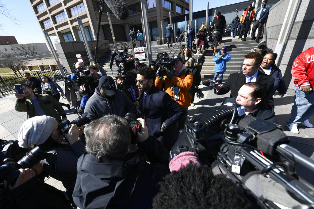 Actor Jussie Smollett, center, leaves the Leighton Criminal Courthouse in Chicago on Tuesday, March 26, 2019, after prosecutors dropped all charges against him. Smollett had been indicted on 16 fe ...