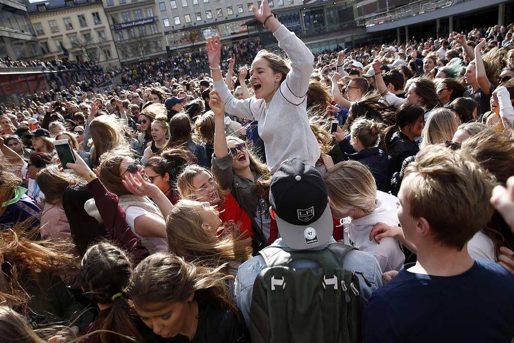 Fans of DJ Avicii gather at Sergels Torg following the news of his death, in central Stockholm, Sweden, Saturday, April 21, 2018. (Fredrik Persson/TT New Agency via AP)