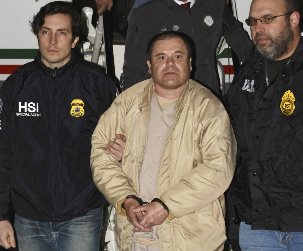 Authorities escort Joaquin "El Chapo" Guzman, center, from a plane to a waiting caravan of SUVs on Jan. 19, 2017, at Long Island MacArthur Airport in Ronkonkoma, N.Y. (United States Drug Enforceme ...