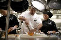 Chef Barry Dakake of Scotch 80 Prime, center, works with culinary arts students including Desti ...