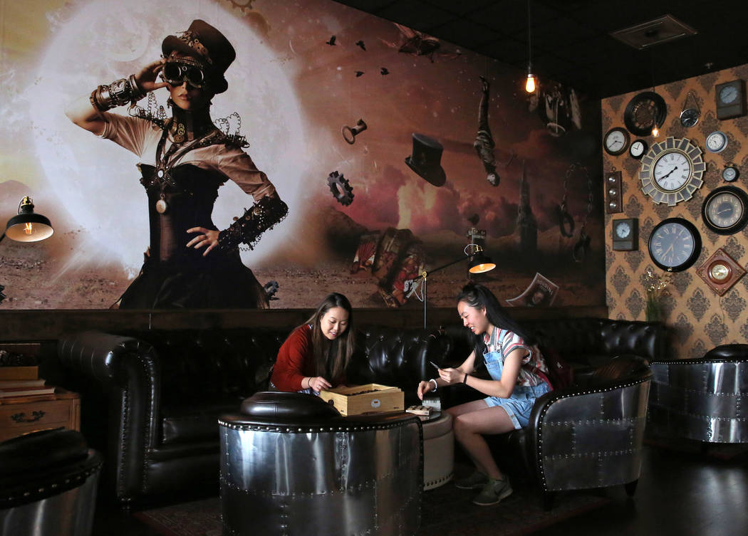 Stephanie Lo, left, and her sister Emily play games at Escapology, where players are locked inside a themed room to play a high adrenaline escape game, before their game on Tuesday, March. 26, 201 ...
