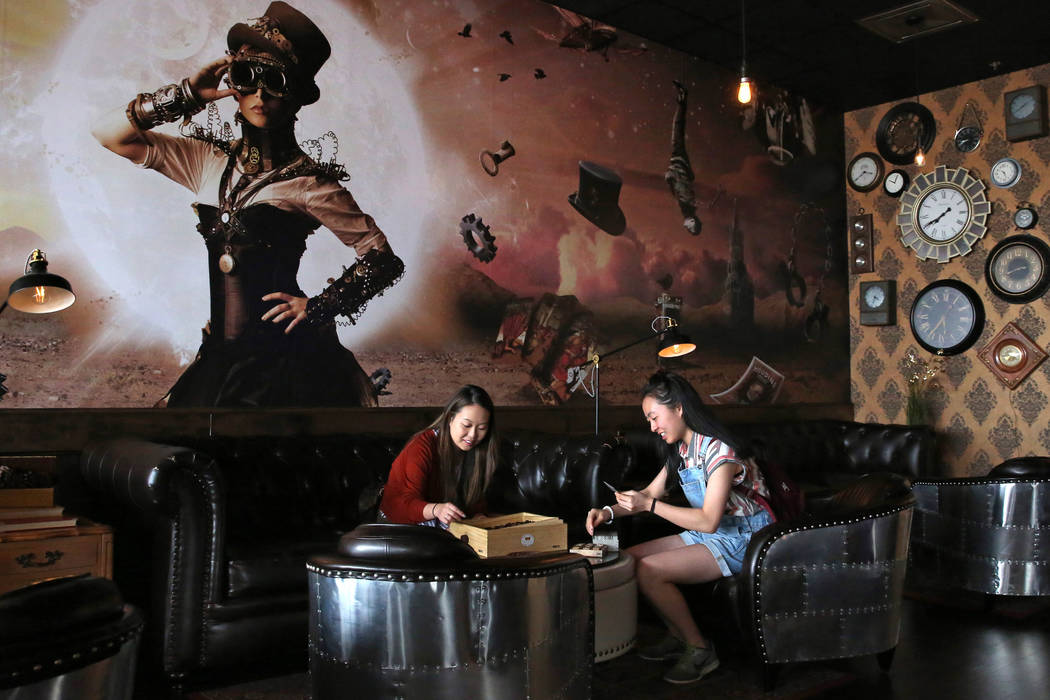 Stephanie Lo, left, and her sister Emily play games at Escapology, where players are locked inside a themed room to play a high adrenaline escape game, before their game on Tuesday, March. 26, 201 ...