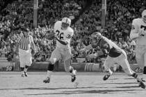 Clem Daniels (36) of the Oakland Raiders races around the right side of his line as Jerry Mays, right, of the Kansas City Chiefs moves in for the tackle, in Kansas City, Mo. on Oct. 31, 1965. (AP ...