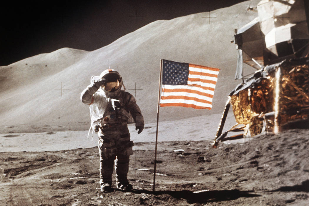 FILE - In this July 30, 1971 photo made available by NASA, Apollo 15 Lunar Module Pilot James B. Irwin salutes while standing beside the fourth American flag planted on the surface of the moon. On ...