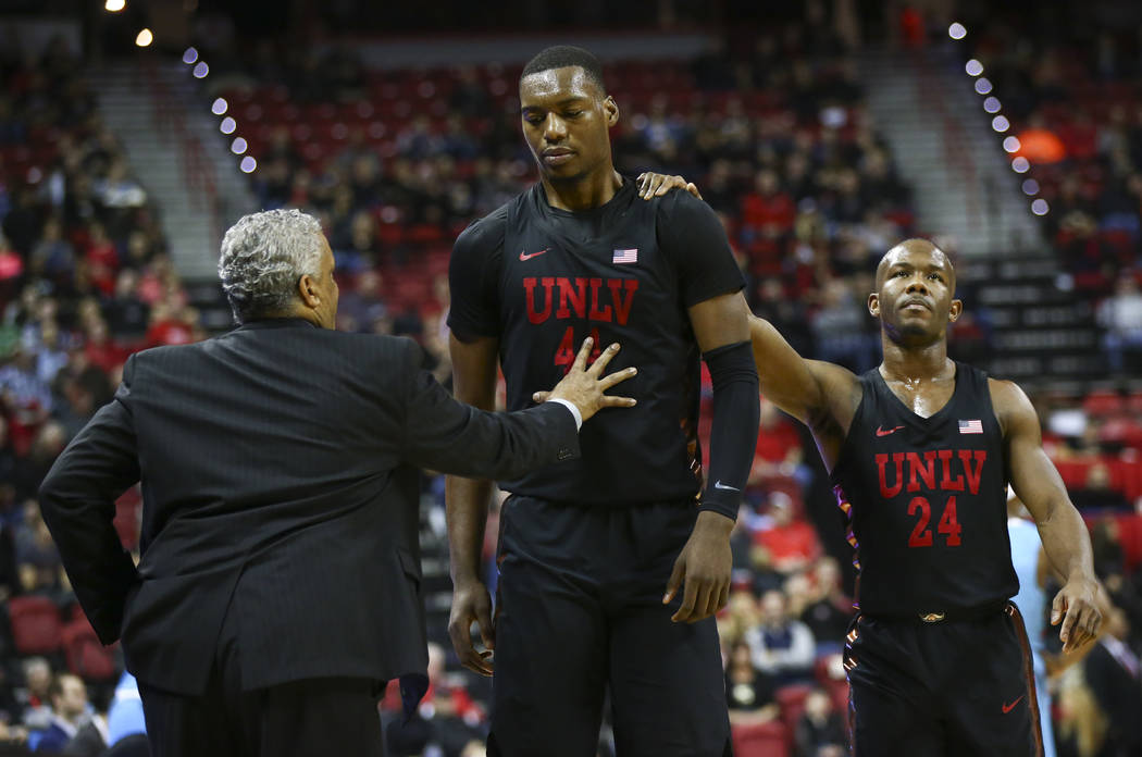 UNLV Rebels guard Jordan Johnson (24) comforts UNLV Rebels forward Brandon McCoy (44) as he returns to the bench after drawing a technical foul during a basketball game at Thomas & Mack Center in ...