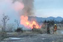 A brush fire at the Wetlands Park, north of Sam Boyd Stadium, burns early Wednesday, March 27, ...