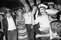 In this July 5, 1976 file photo, head pilot Michel Bacos, center left, is reunited with his wife and son at Orly Airport near Paris, France, as the 12-member crew of the hijacked Air France Airbus ...