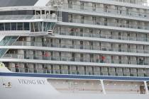 Some of the remaining passengers look out as the cruise ship Viking Sky arrives at port off Molde, Norway, Sunday March 24, 2019, after having problems and issuing a Mayday call on Saturday in hea ...