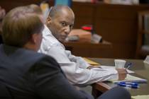 Defendant Leonard Woods, right, consults with his counsel during closing arguments on Monday, M ...