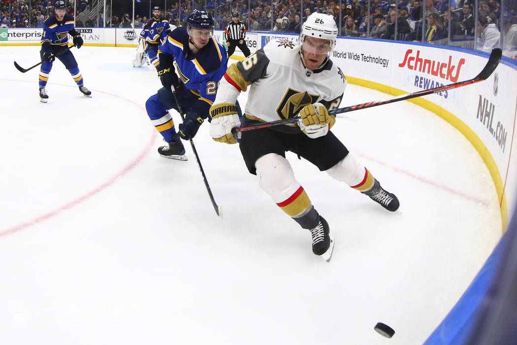 St. Louis Blues' Vince Dunn (29) and Vegas Golden Knights' Paul Stastny (26) case down the puck ...