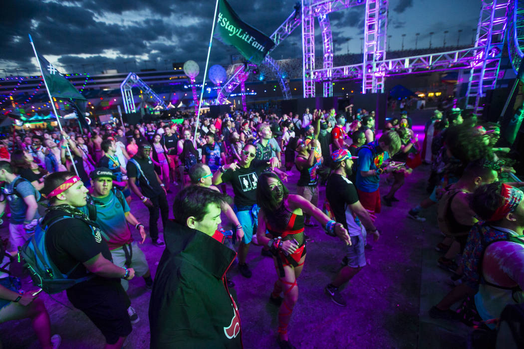 Attendees dance as Dateless performs at the Stereobloom stage during the third day of the Elect ...