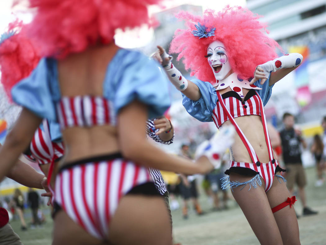 Costumed performers entertain fans by the Cosmic Meadow stage during the third day of the Elect ...