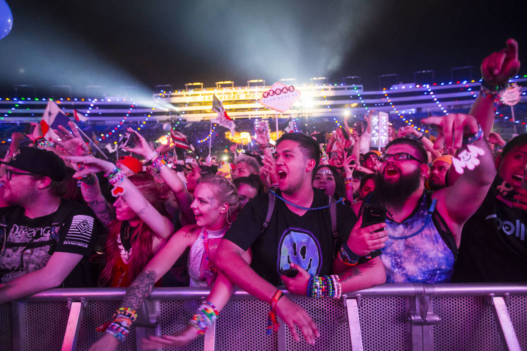 Attendees sing along as Post Malone performs at the Cosmic Meaddow stage during the third day o ...