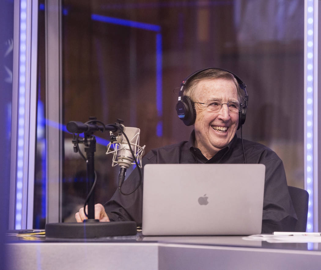 Brent Musburger shares a laugh with staff members during a live broadcast covering opening rou ...