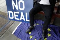 A pro Brexit campaigner sits with a banner outside Parliament in London, Wednesday, March 27, 2019. British lawmakers WERE preparing to vote Wednesday on alternatives for leaving the European Unio ...
