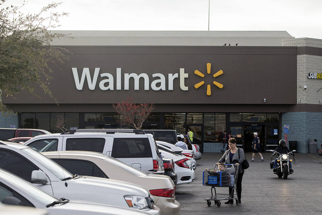Shoppers exit Walmart at Cheyenne Commons strip mall on Thursday, Dec. 20, 2018, in Las Vegas. ...