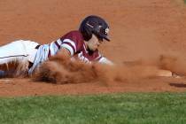 Cimarron-Memorial baserunner Lawrence Campa (15) slides safely into third base in the third inn ...
