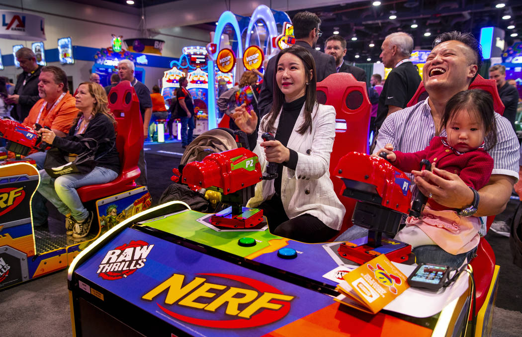 Hwa Yeon Lee with husband James and daughter Vivian, 2, with FunXcess enjoy a turn on the Nerf ...