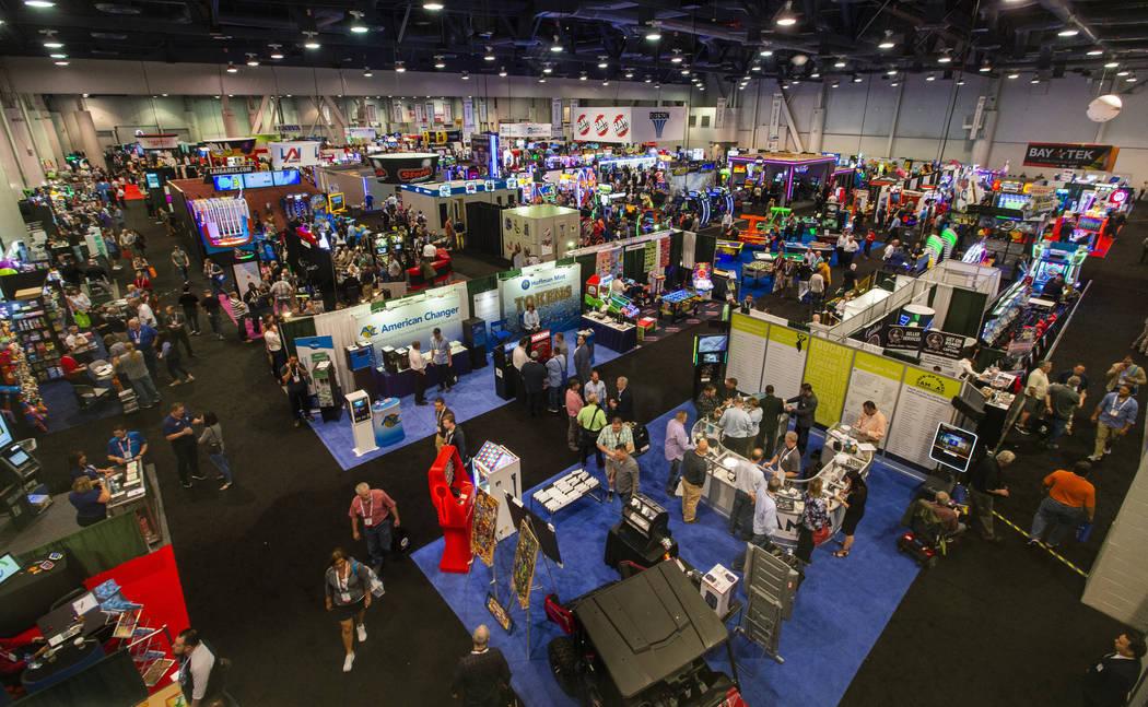 The showroom floor is packed with games and other merchandise to test out during the Amusement ...