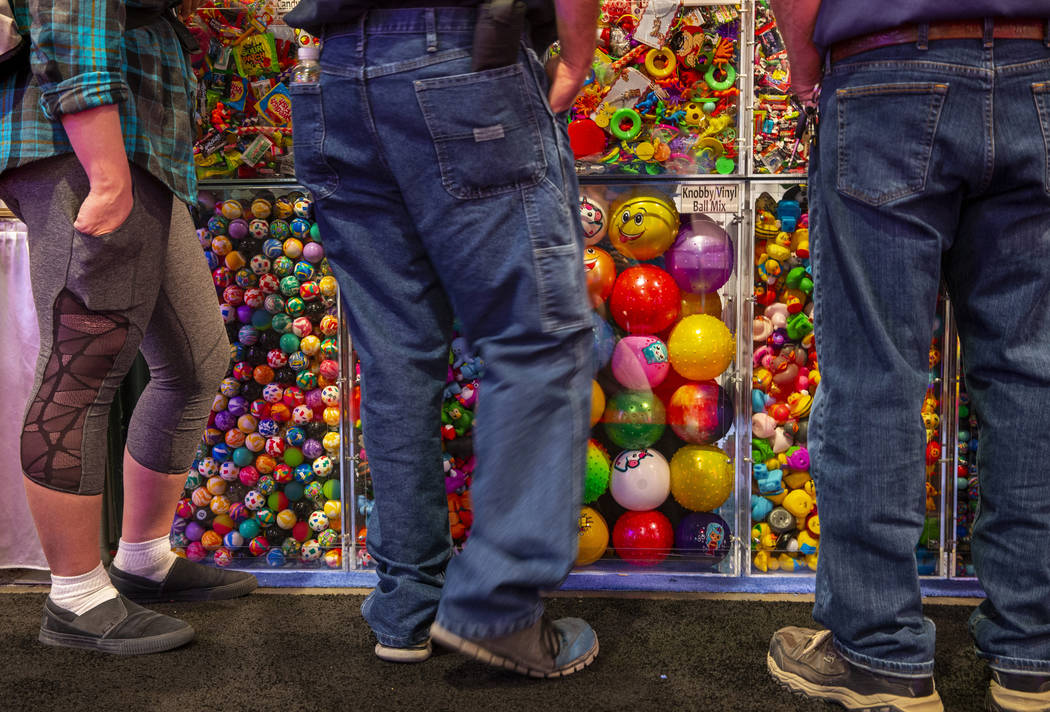 Attendees view some of the many game prizes for sale during the the Amusement Expo at the Las V ...
