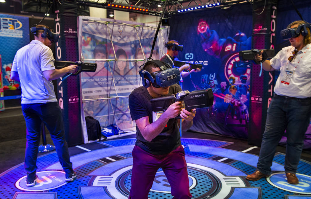 Attendees take a turn defending themselves on the Holgate game by Creative Works during the the ...