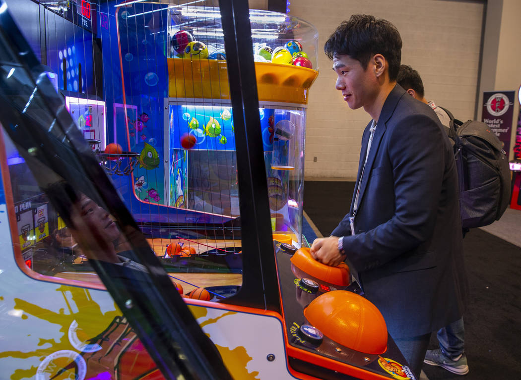 Sung Min Youn with Coastal Amusements Inc., plays a mini basketball game during the Amusement E ...