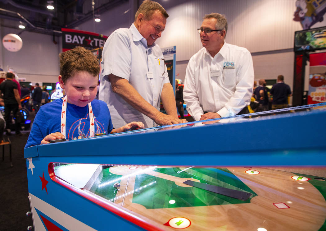 Aiden Fortier with Gamepath Arcade plays a baseball game during the the Amusement Expo at the L ...