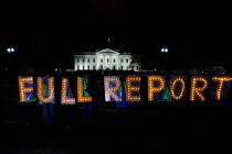 Members of the protest group Herndon Reston Indivisible and Kremlin Annex hold signs saying &qu ...