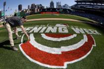 Andy Burnette, of the PNC Ground Crew paints, the Opening Week logo on the field at PNC Park We ...