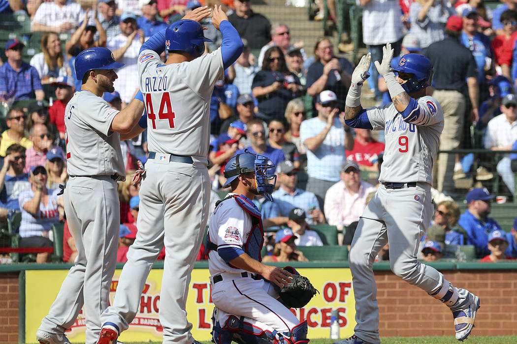 Chicago Cubs' Mark Zagunis (2) and Anthony Rizzo (44) greet Javier Baez (9) at home plate after ...