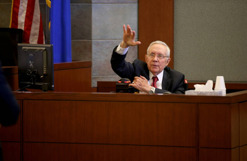 Former U.S. Sen. Harry Reid testifies in the courtroom at the Regional Justice Center in downto ...