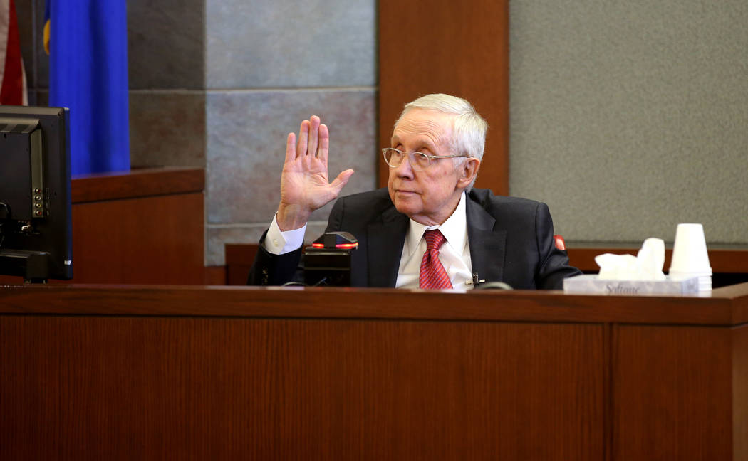 Former U.S. Sen. Harry Reid is sworn in on the witness stand at the Regional Justice Center in ...
