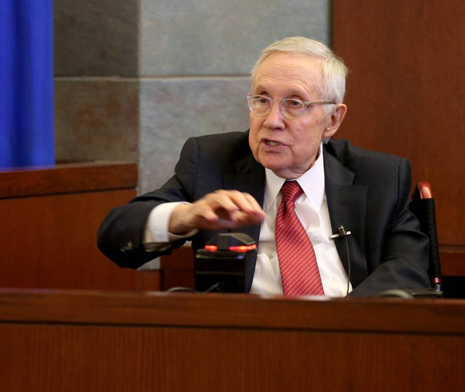 Former U.S. Sen. Harry Reid testifies in the courtroom at the Regional Justice Center in downto ...