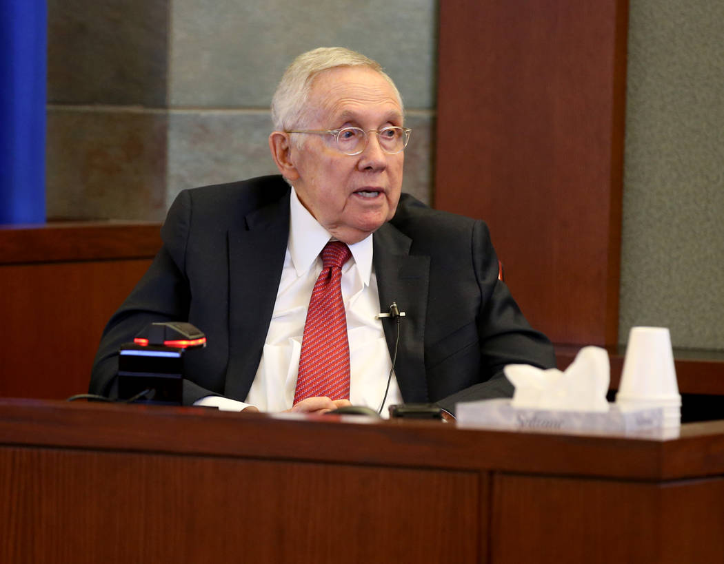 Former U.S. Sen. Harry Reid testifies in the courtroom at the Regional Justice Center in downto ...