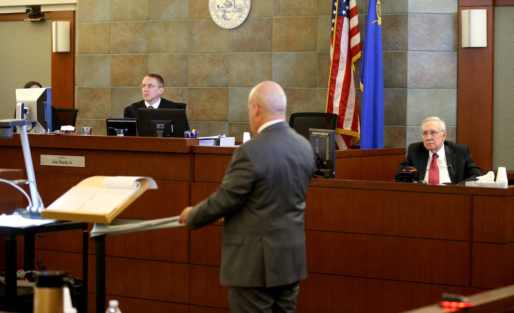 Former U.S. Sen. Harry Reid is questioned by attorney Laurin Quiat, using exercise band, as Dis ...