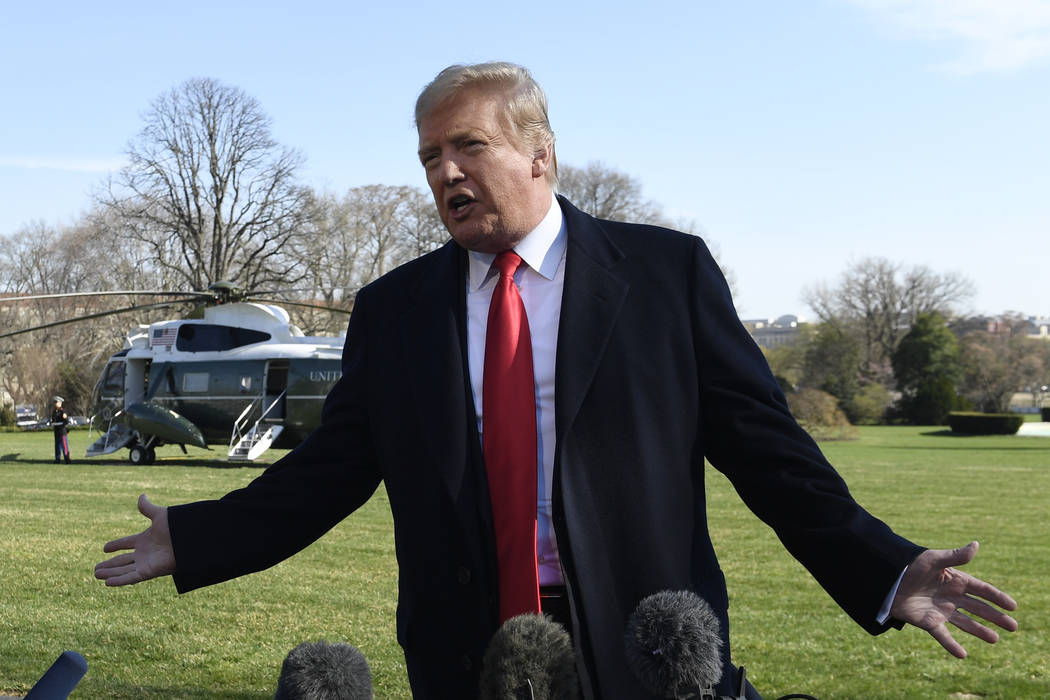 President Donald Trump talks with reporters before boarding Marine One on the South Lawn of the ...