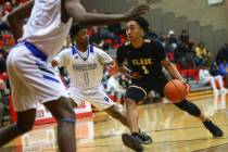 Clark's Frankie Collins (1) drives against Desert Pines' Semaj Threats (1) during the second ha ...