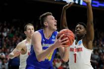 South Dakota State forward Mike Daum, left, puts up a shot against Ohio State forward Jae'Sean ...