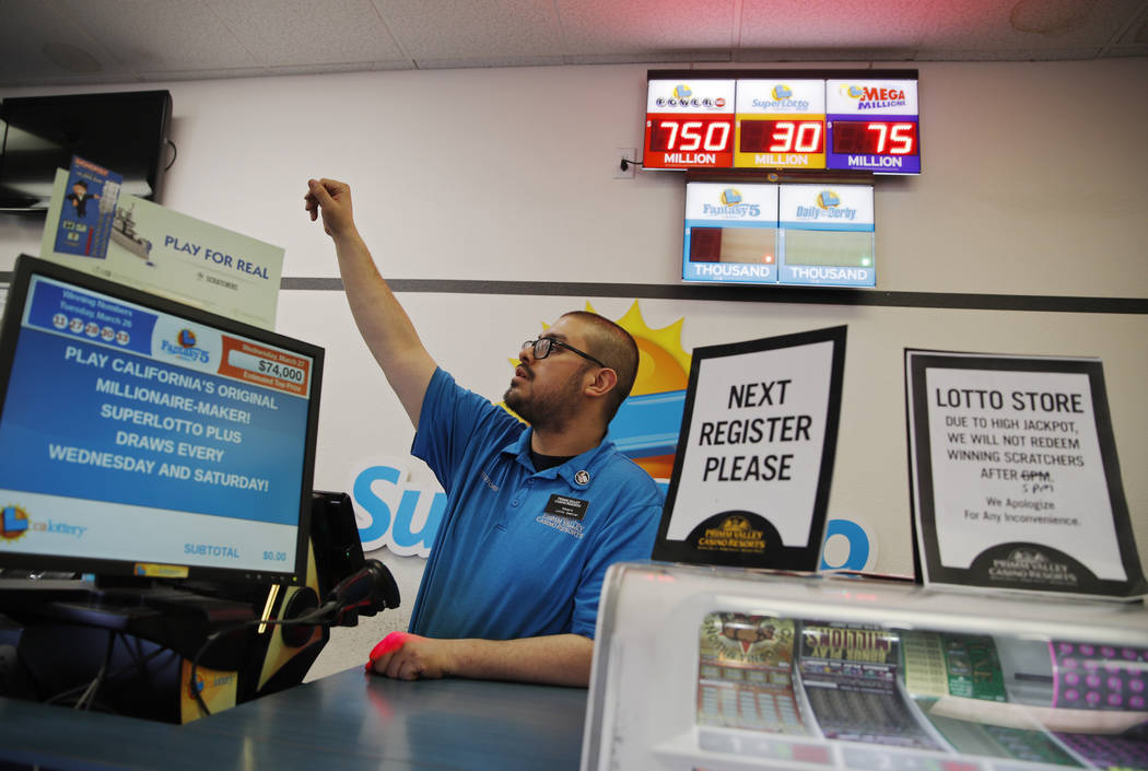 Cashier Edward Kelliher sells lottery tickets at the Lotto Store at Primm just inside the Calif ...