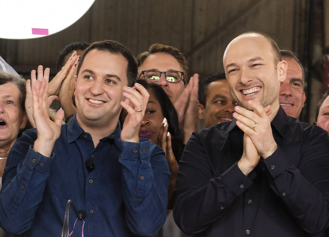 Lyft co-founders John Zimmer, left, and Logan Green cheer as they as they ring a ceremonial ope ...