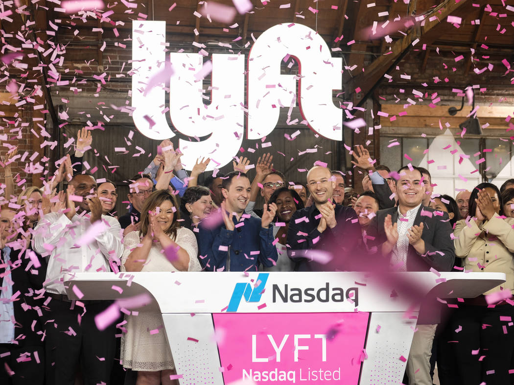 Lyft co-founders John Zimmer, front third from left, and Logan Green, front third from right, c ...