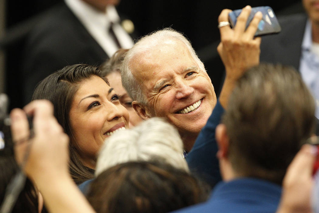 Lucy Flores, left, and Vice President Joe Biden, take a photo together during a get out the vot ...