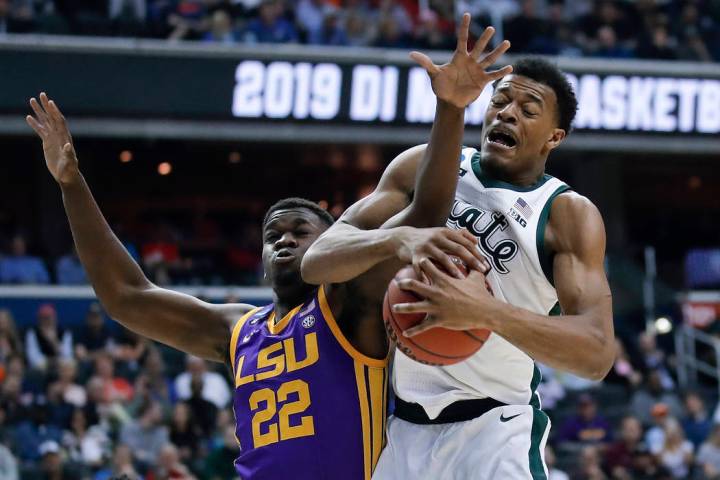 Michigan State forward Xavier Tillman (23) beats out LSU forward Darius Days (22) for the loose ...