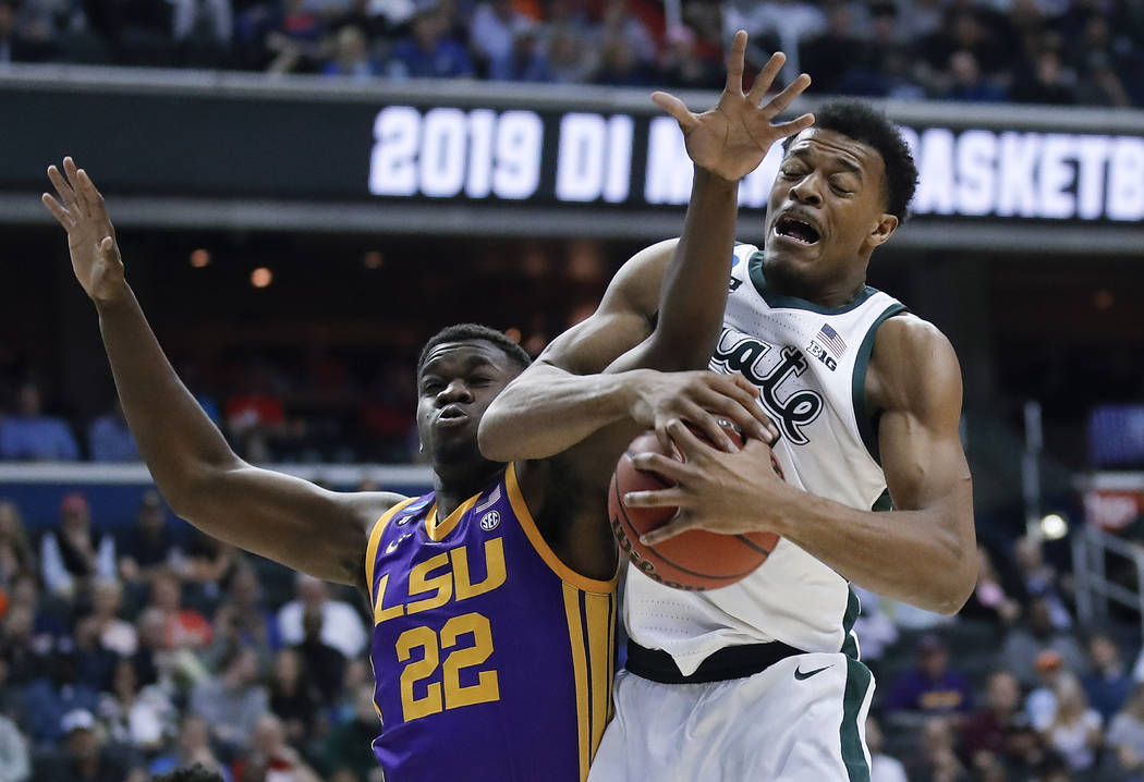 Michigan State forward Xavier Tillman (23) beats out LSU forward Darius Days (22) for the loose ...